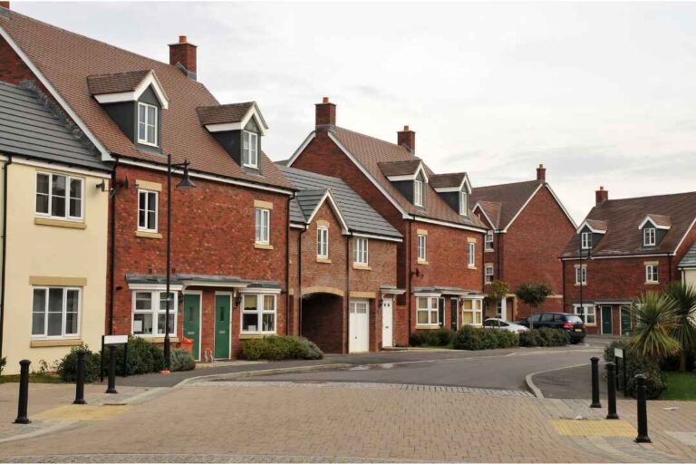 Modern townhouses in a newly developed residential area of Kentish Town, showcasing red-brick architecture, clean streets, and contemporary urban planning.