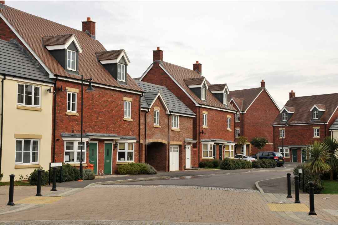 Modern townhouses in a newly developed residential area of Kentish Town, showcasing red-brick architecture, clean streets, and contemporary urban planning.