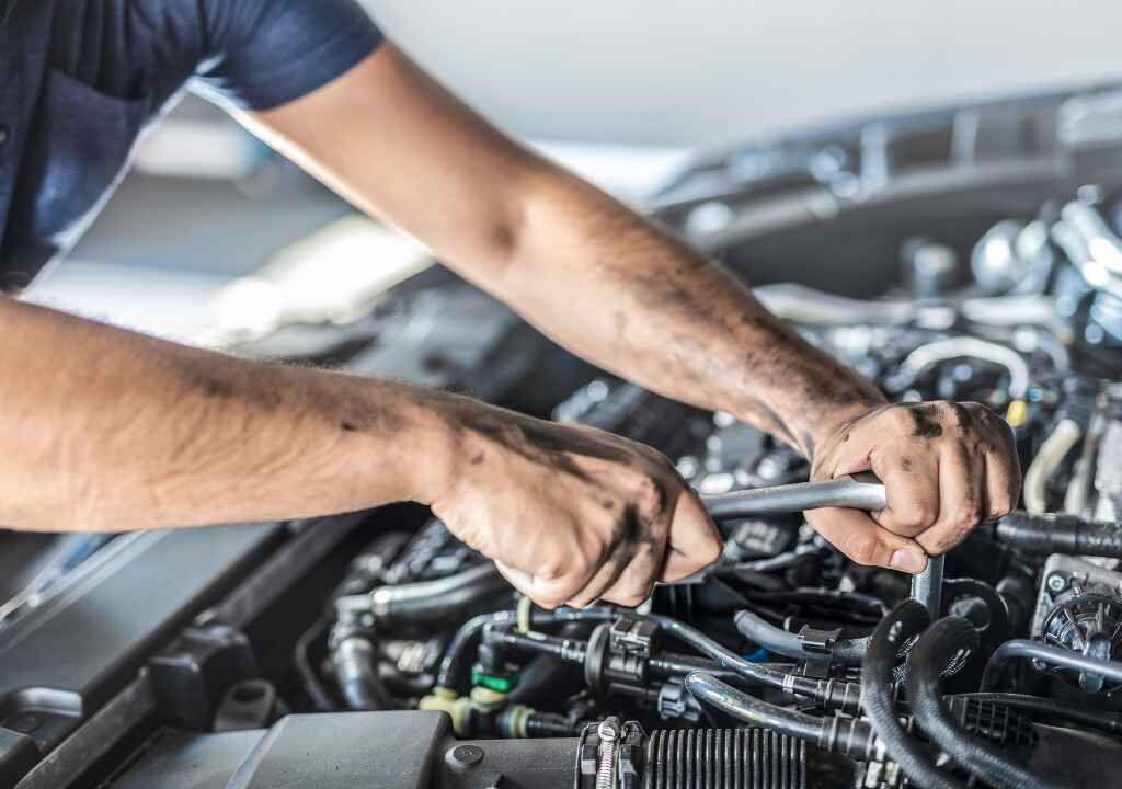 Mechanic working on engine showing how tight are diesel engine valves during valve adjustment