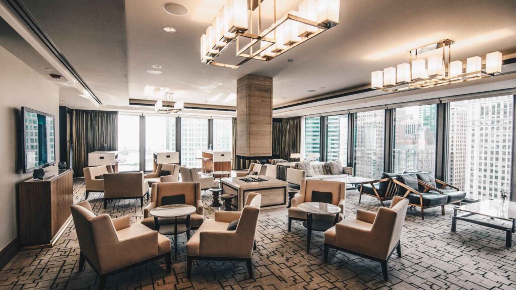 Modern lounge in a high-rise special housing area with city views and luxury seating