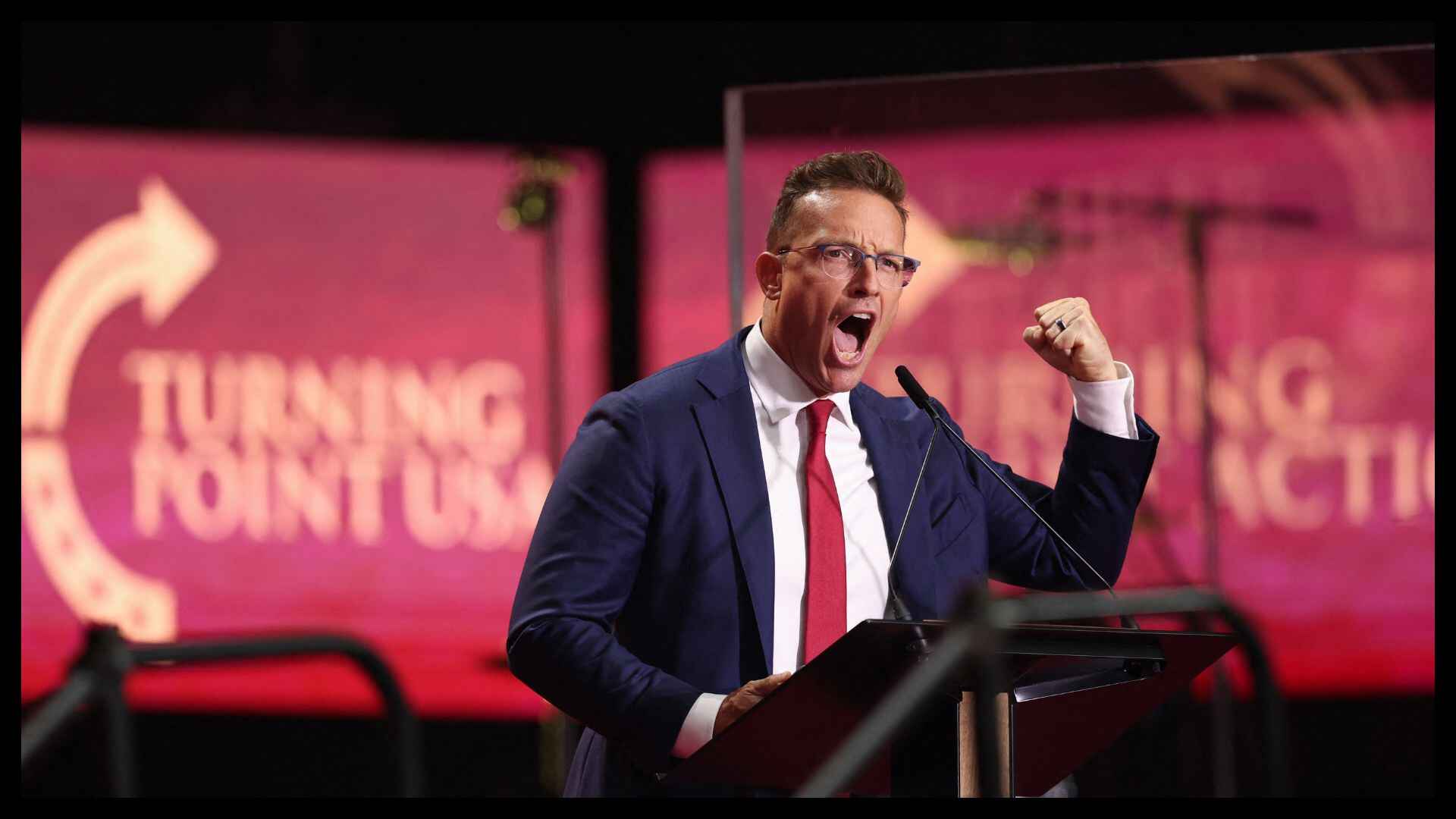Benny Johnson speaking passionately at a Turning Point USA event amid controversy surrounding threats from George Isbell Jr.