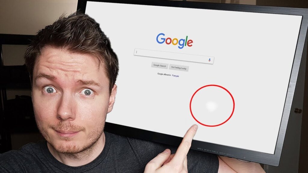 Man pointing at a white spot on Lenovo laptop screen showing display issue.